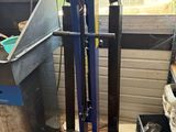 a blue hand truck that is sitting in front of a window