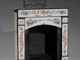 a small black and white fire place with a clock on top