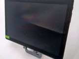 a tablet computer sitting on a stand on a white surface