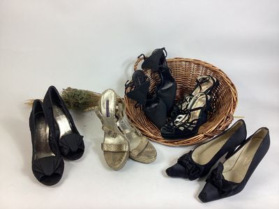several pairs of shoes and a basket on a white surface