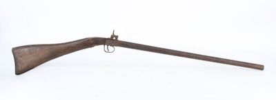 an old rifle with a wooden barrel on a white background