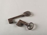 two old keys that are sitting on a table