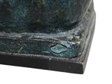 a close up of a statue of a cat on a pedestal