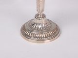 an image of a silver plate with a candle holder on it