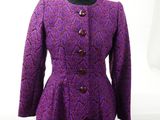 a close up of a purple jacket and skirt suit on a mannequin