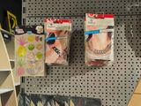 two boxes of jewelry hanging on a wall in a store
