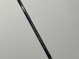 a close up of a black and gold badminton racket on a white surface
