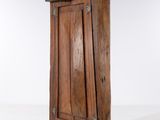 a small wooden cabinet with a door on it