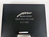 a black box with a silver and black logo on it