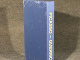 the blue book is sitting on the floor next to a brown carpet