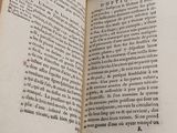 an open book on a table with a white background