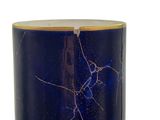 a blue vase with a crack in it on a white surface