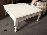 a white table with a drawer on it in a room