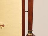a clock that is sitting on a stand with a clock on it