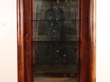 an antique wooden display cabinet with a glass door and gold trimmings