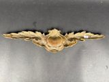 a close up of a metal object with a bird on it ' s back