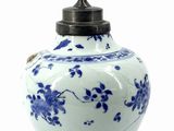 a blue and white vase with a lid on a white background