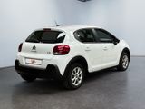 the rear of a white citrole parked in a garage