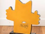 a wooden sign with a cartoon character on it