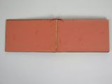 an open book sitting on top of a table next to a white wall