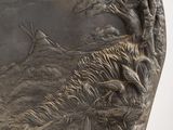 a silver plate with a picture of a boat and birds on it