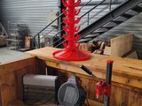 a red fire hydrant that is on a wooden table