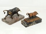 pair of bronze figurines of a bull and a bull on a marble base