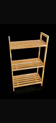 a wooden shelf with three shelves on top of it