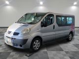 a silver van that is parked on a checkered floor
