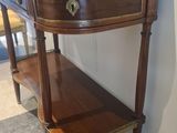 a small table with a shelf on it in a room