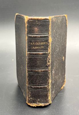 an old book sitting on top of a black table
