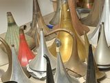 a lot of different types of bells on the floor