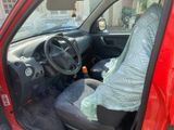 a red car with a blue blanket on the front seat