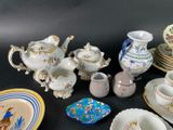 many different types of porcelain dishes and cups on the table