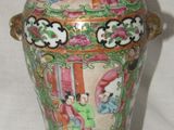 a vase that has a bird on top of it