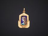 a gold pendant with a portrait of a woman in a blue dress