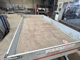 a trailer with a flat bed in a warehouse