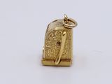 an image of a gold elephant charm on a white background