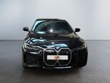 the front view of a black bmw car in a white room