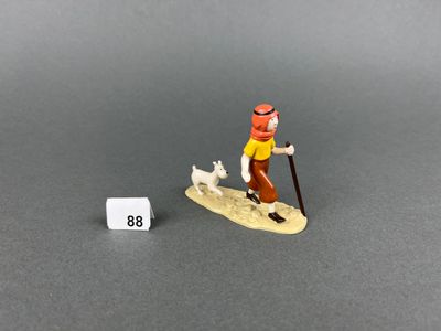 miniature figurine of a man on a surfboard with a dog