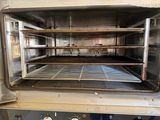 an open oven with a rack in the middle of it