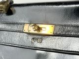 a close up of a black leather bag with a lock