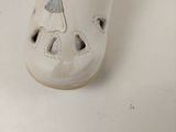 a close up of a child ' s shoe on a white surface