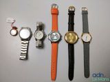 several different watches are lined up on a table