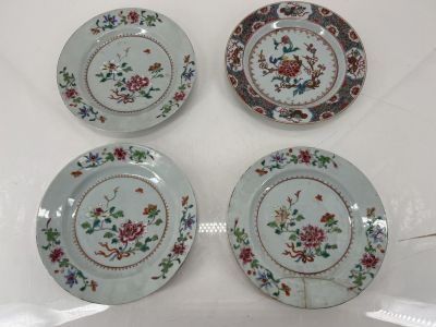 three plates with floral designs on them sitting on a table