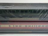 two boxed train cars sitting on top of each other on a table