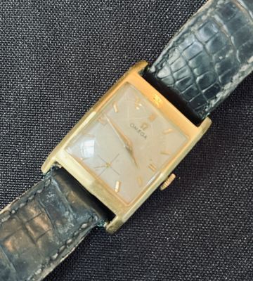 a watch that is sitting on a black cloth