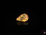 an image of a yellow diamond sitting on top of a black surface