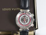 a close up of a watch with a box in the background