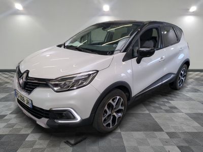 a white car is parked on a checkered floor in a garage